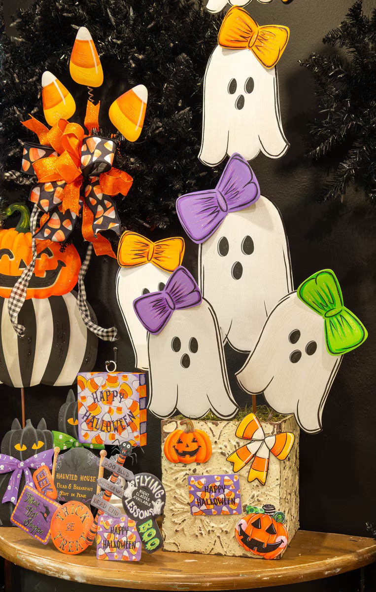 36-inch metal ghost topiary featuring three white ghosts with colorful bows, set in a decorative base for Halloween.