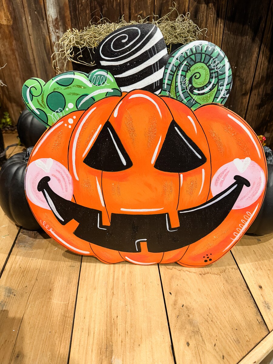 14-inch orange Jack O Lantern wall decor with black carved face, pink cheeks, and whimsical green and black accents.