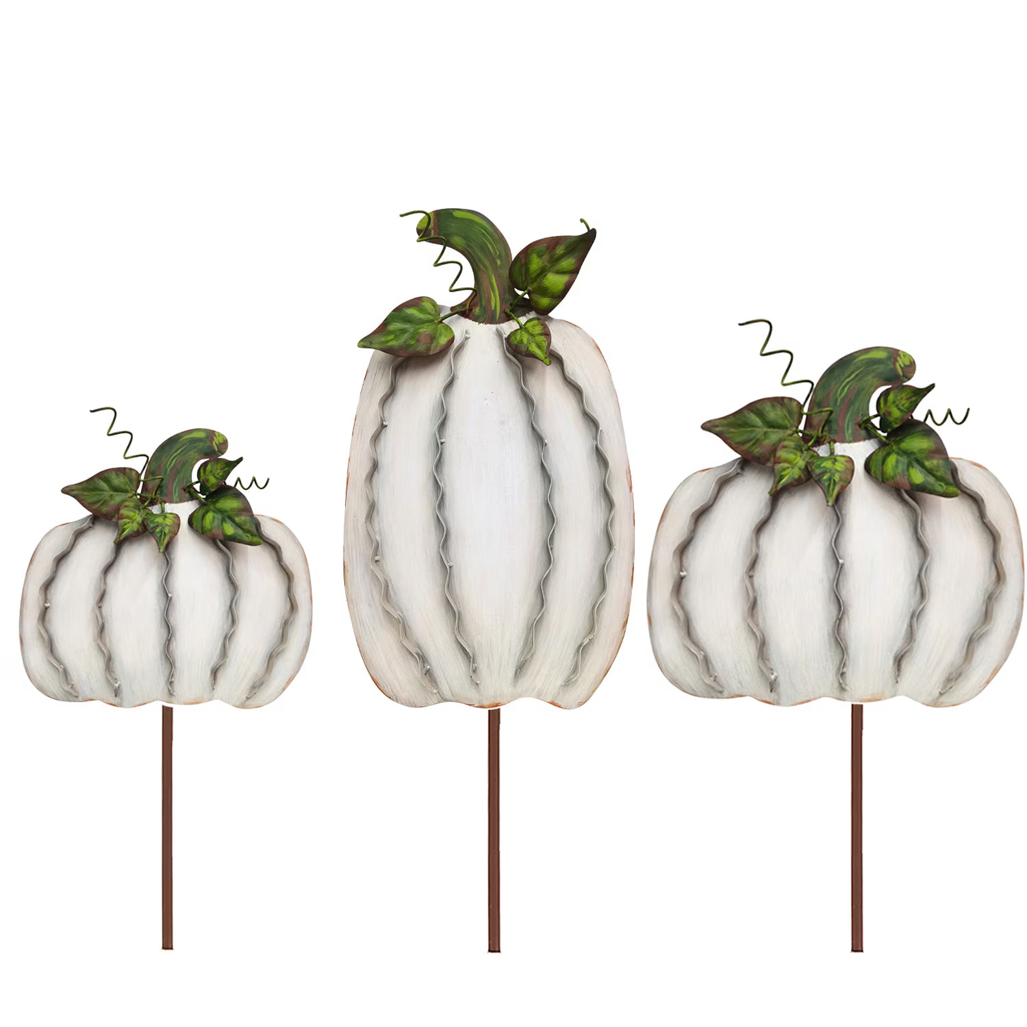 Set of three cream-colored metal ribbon pumpkins on stakes with green leaf and vine accents for fall decor.