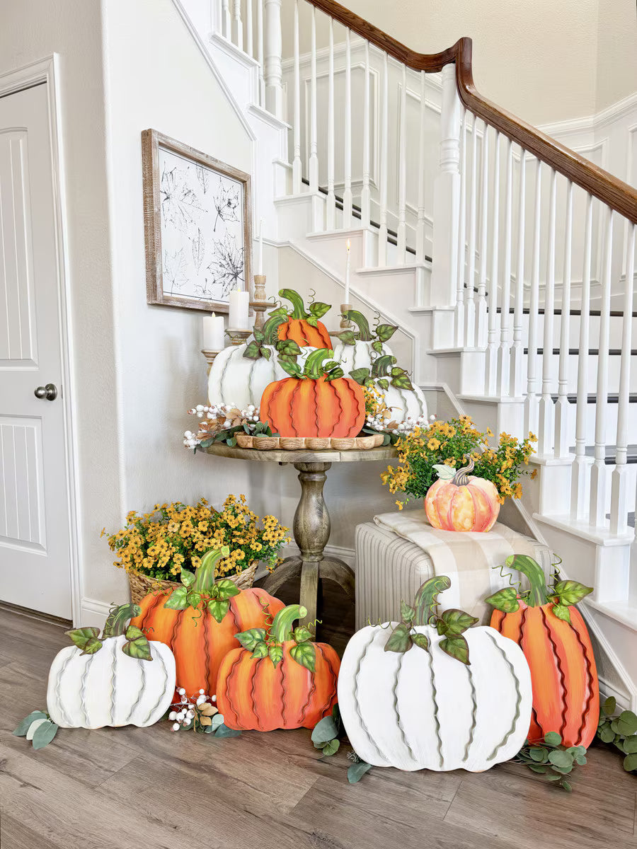 Set of three cream and orange ribbon pumpkins with green leaves, displayed as festive autumn home decor.