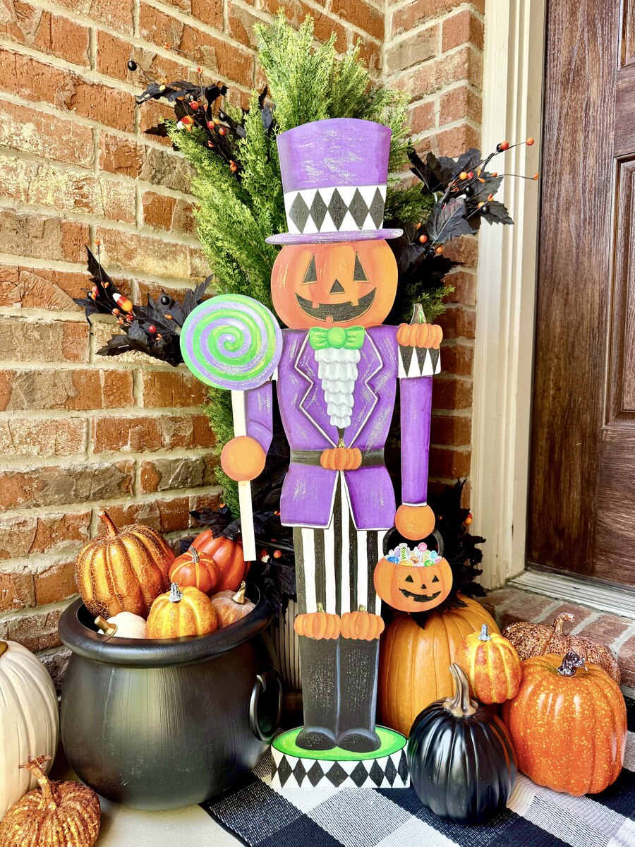 35.5-inch metal Jack O Lantern nutcracker in a purple suit and top hat, holding a lollipop and pumpkin bucket.