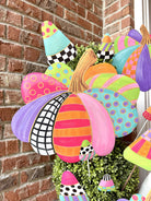 Colorful 19-inch pumpkin garden stake featuring vibrant patterns, polka dots, and stripes in a whimsical, festive autumn style.