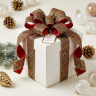 Ruby and emerald diamond dust wired ribbon bow on gift box