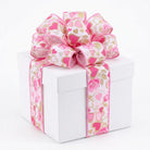Sculpted pink heart bow on white gift box showcasing wired ribbon shape retention