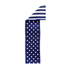 Navy blue polka dot wired edge ribbon with white striped reverse side and reinforced stitching