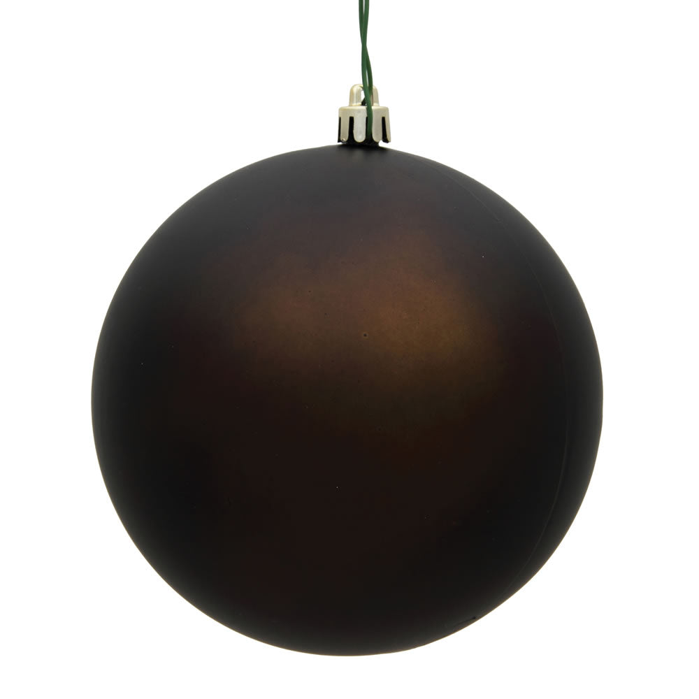 Close-up of matte brown holiday ornament detail showing drilled silver cap and green wire