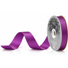 Flexible non-wired purple satin ribbon unspooled showing drape