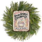 Decorative wreath with a sign for Sugar Sparkle Cauldron Co. on a white background