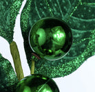 Emerald green velvet holly spray with glitter-edged leaves and two metallic green berries on wired stems.