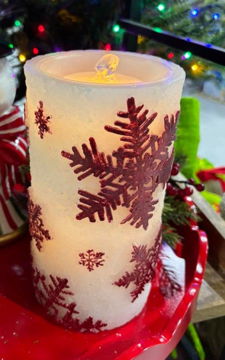 7.75-inch white wax LED pillar candle with shimmering red snowflake patterns and a bubbling water fountain effect.