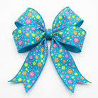 Pre-tied teal snowflake wired ribbon bow showing shape retention