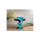Turquoise wired edge ribbon draped on black stand with greenery