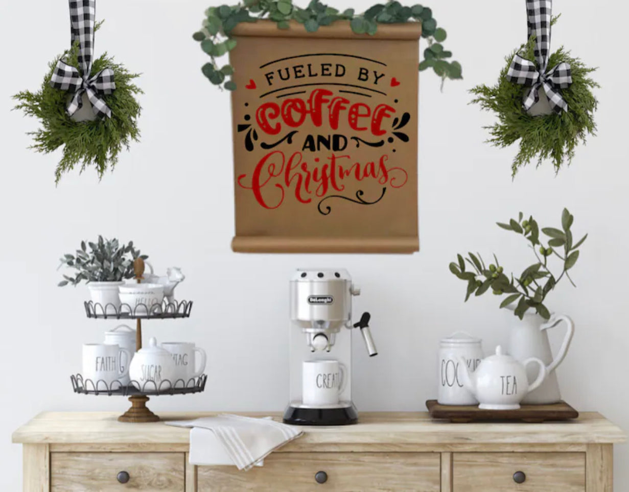Two mini artificial cedar wreaths with black and white buffalo check ribbons hanging above a coffee station.
