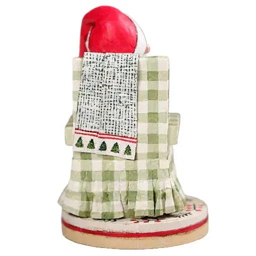Lori Mitchell 7-inch poly resin Santa figurine sitting in a green checkered chair with a patterned throw blanket.