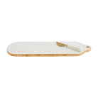 White marble serving board with gold foiled edges and matching brass-finished spreader with marble handle.