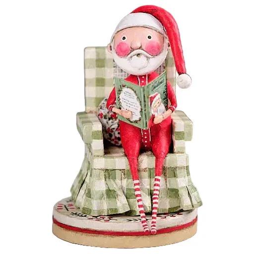 Lori Mitchell 7-inch Santa figurine in a green checkered chair reading a book, hand-painted poly resin folk art style.